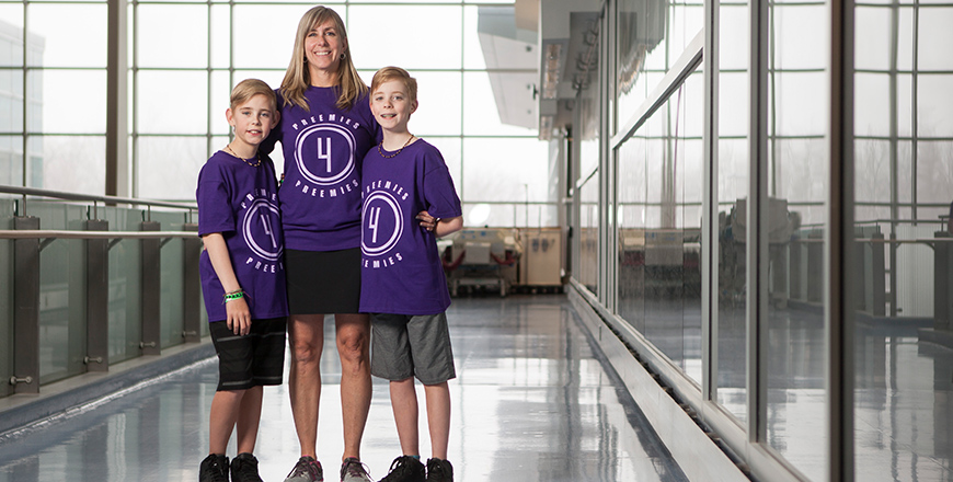 Liam and Rhys stand on either side of their mother Nora