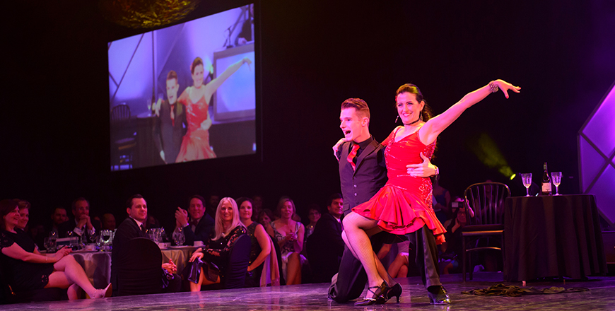 A dancing doc and his partner pose dramatically during their performance