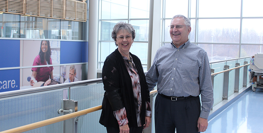 Clinical trial participant Charles Berniqué laughs with his wife..