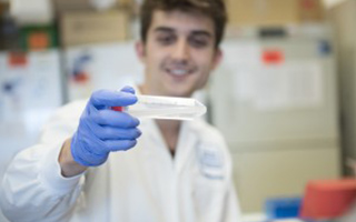 Researcher holding plastic tube