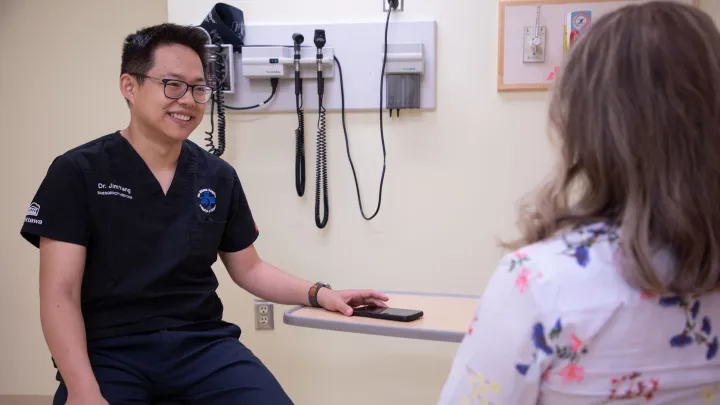 Emergency Department physician Dr. Jim Yang speaks with a patient.