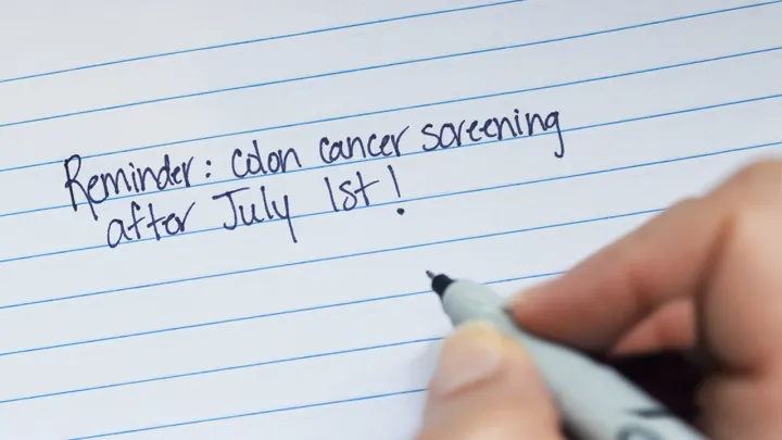 A handwritten note that says “Reminder: colon cancer screening after July 1st!”