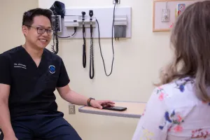 Emergency Department physician Dr. Jim Yang speaks with a patient.