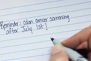 A handwritten note that says “Reminder: colon cancer screening after July 1st!”