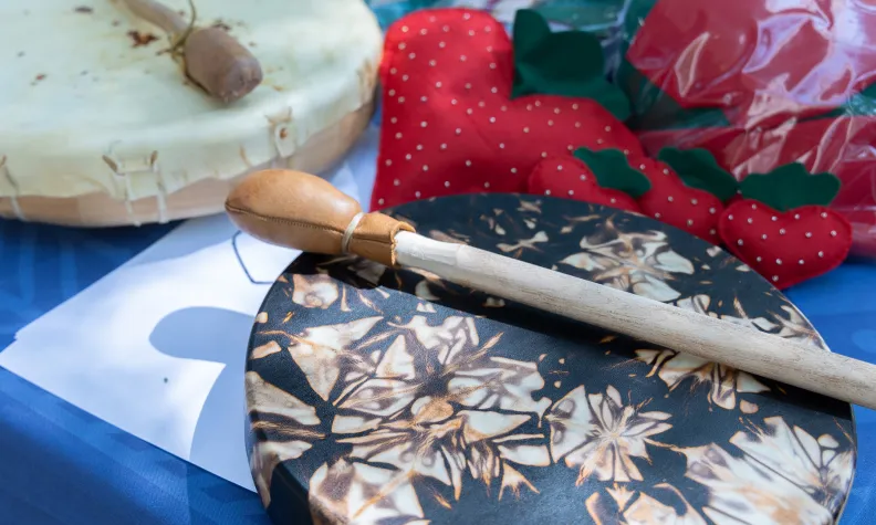 The Ontario Native Women’s Association table showcases drums and strawberry-themed sewing crafts.