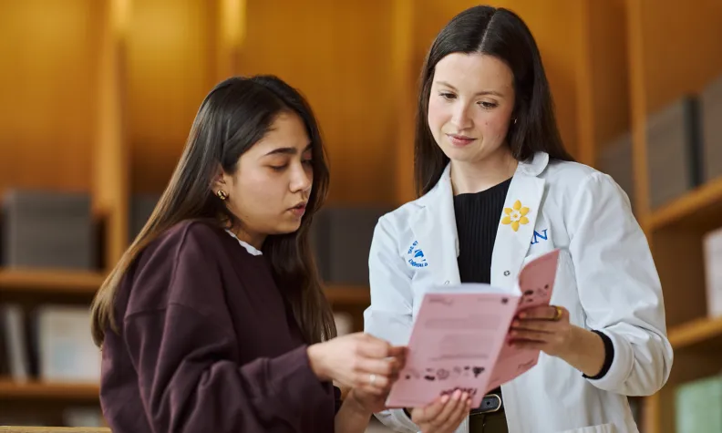 Healthcare provider helping a patient review care information and support resources.