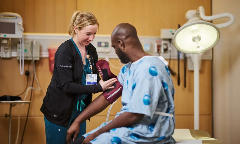 Nurse providing hands-on patient care during a routine clinical procedure.