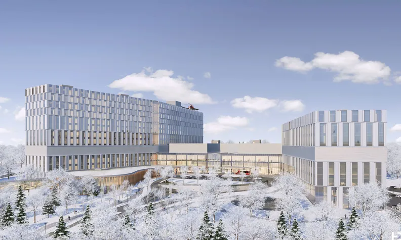An artist rendering of the exterior of the new hospital on a winter day, showing snow-covered trees in the foreground. 