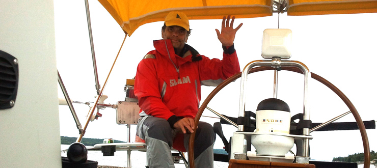 Peter Juryn in sailboat waving