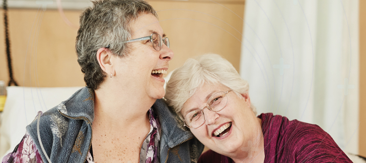 two women are happily laughing