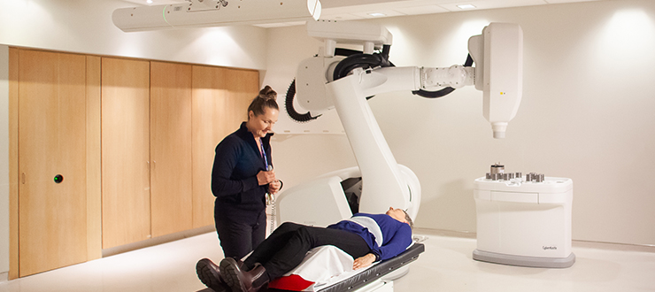 Radiation therapist Julie Gratton is delivering a Cyberknife treatment for a patient