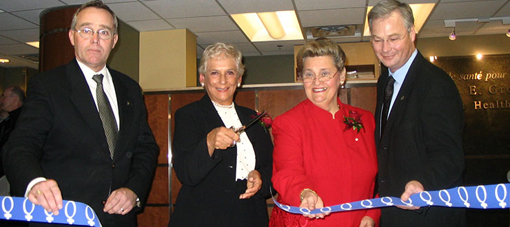 Shirley E. Greenberg is inaugurating the centre by cutting the ribbon.