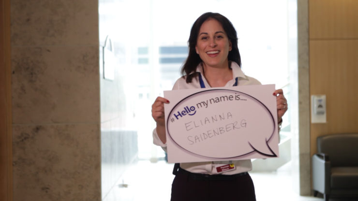 Dr. Saidenberg is holding a "Hello My name is" poster