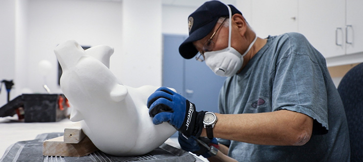 Saila Kipanek carves a piece of stone