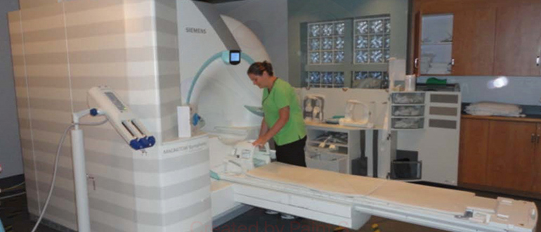 hospital worker using an MRI machine