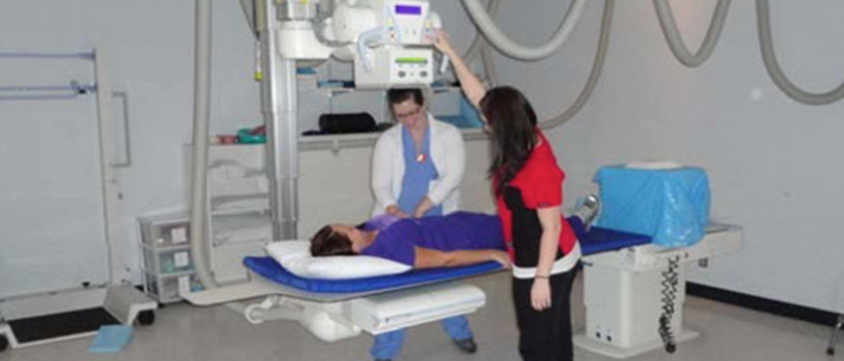 two hospital workers performing an X-Ray on a patient