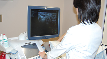 a hospital employee observing ultrasound pictures