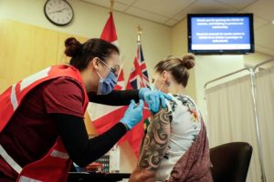 Jo-Anne Miner receives the first dose of the the COVID-19 vaccine. Right: Jo-Anne Miner recives the second dose of the COVID-19 vaccine.