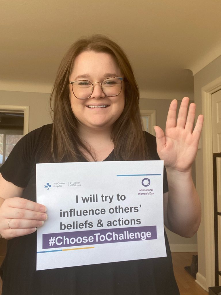 Megan Ellis holds a #ChooseToChallenge sign