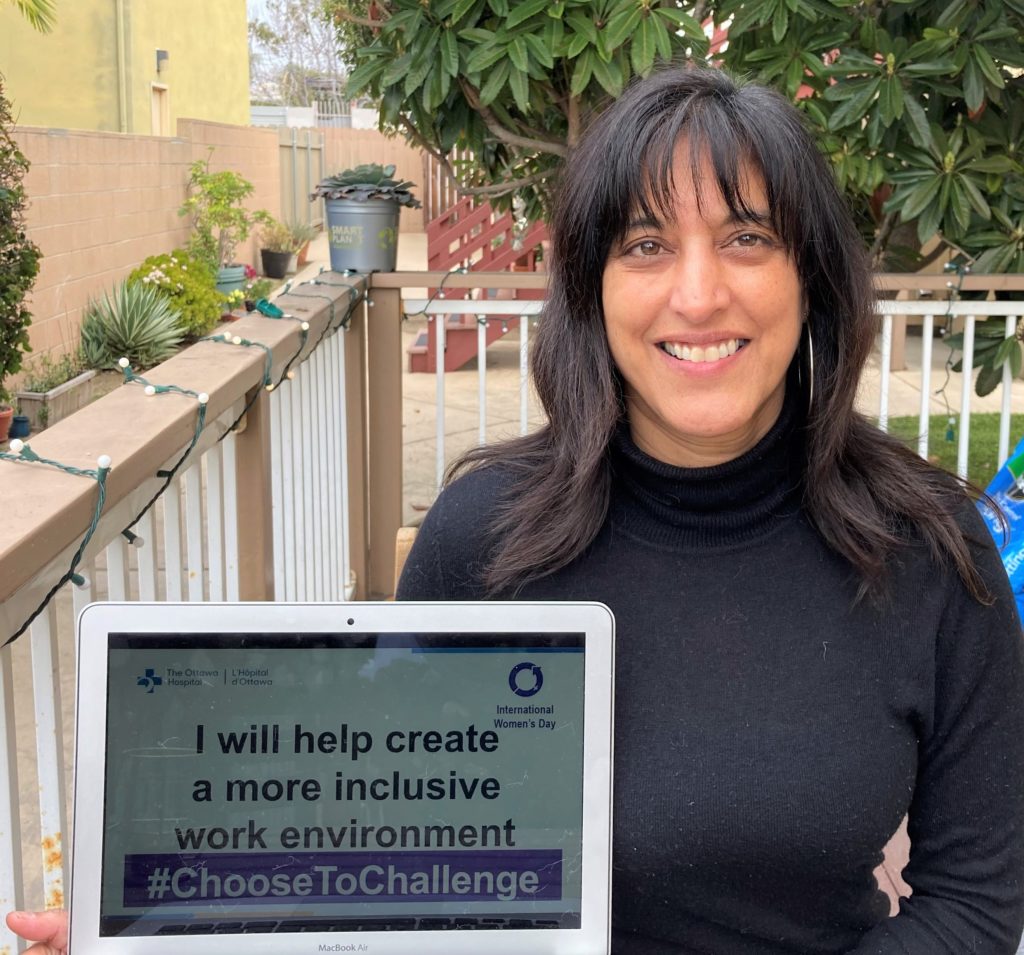 Dr. Camille Munro holds a #ChooseToChallenge sign