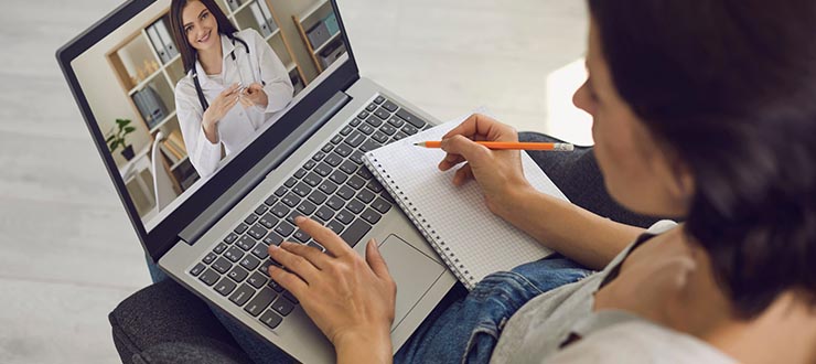 Woman talks to her doctor via her laptop