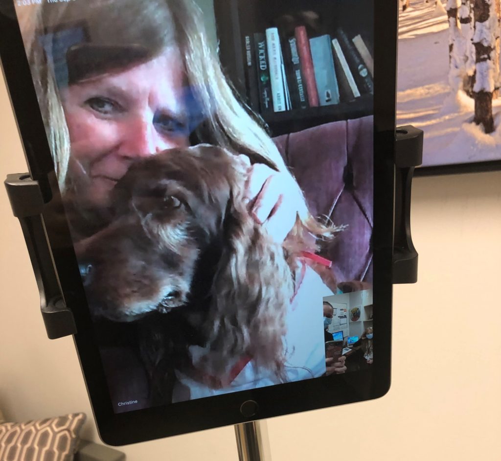 Christine Sinclair and therapy dog Caleigh appearing on a tablet