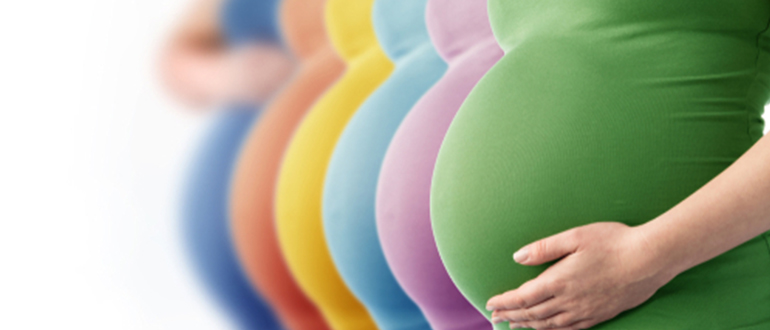 Six pregnant women standing in a row.