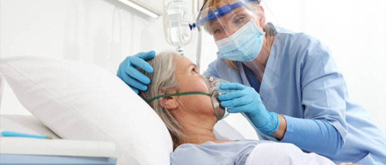 A nurse is giving respiratory therapy to the patient