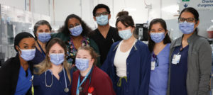 A group of nine nurses wearing face masks
