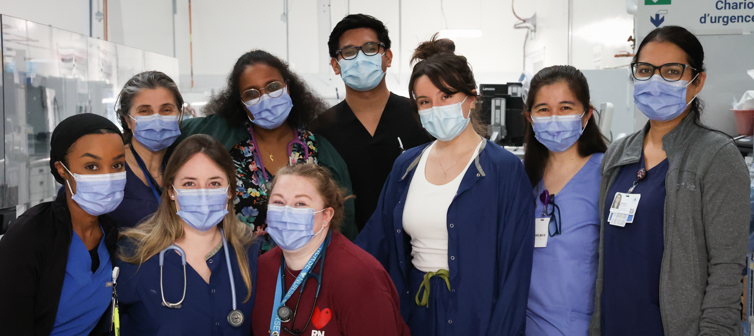 A group of nine nurses wearing face masks