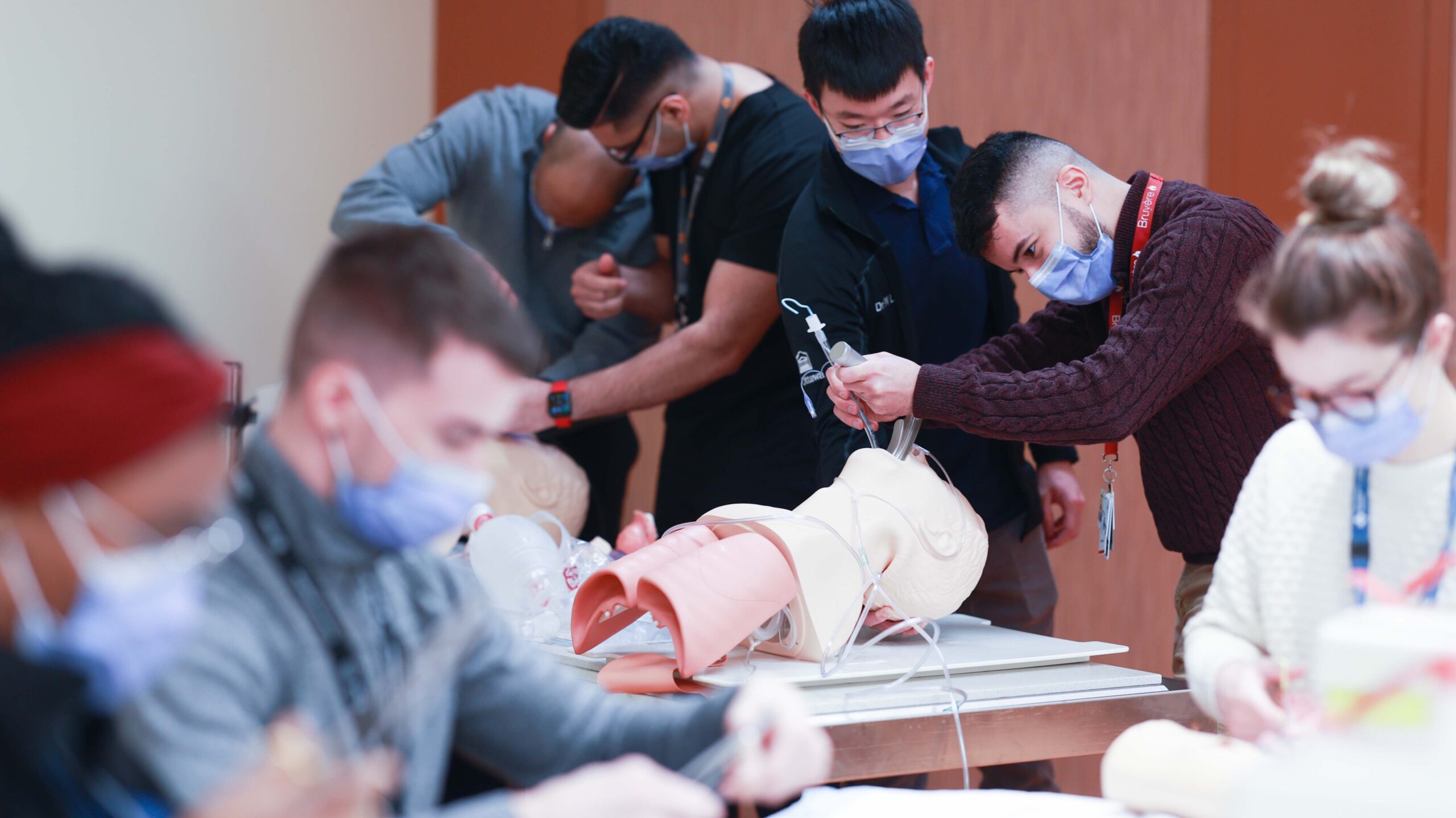 Medical students and attendings practice on mannequins 