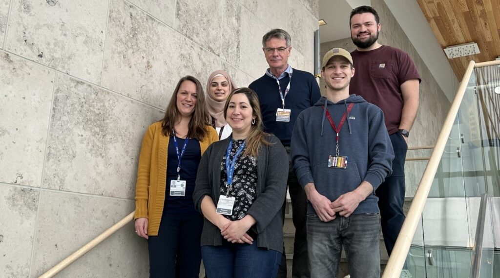 Members of the Cancer therapeutics Program Green Team standing on stairs