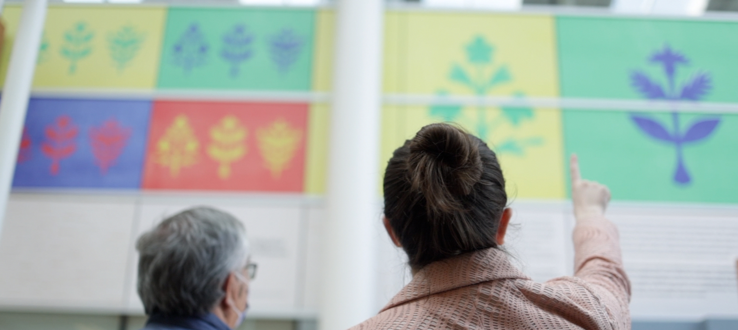 The Ottawa Hospital’s land acknowledgement sign with artists Simon Brascoupé (left) and Mairi Brascoupé (right) in the foreground