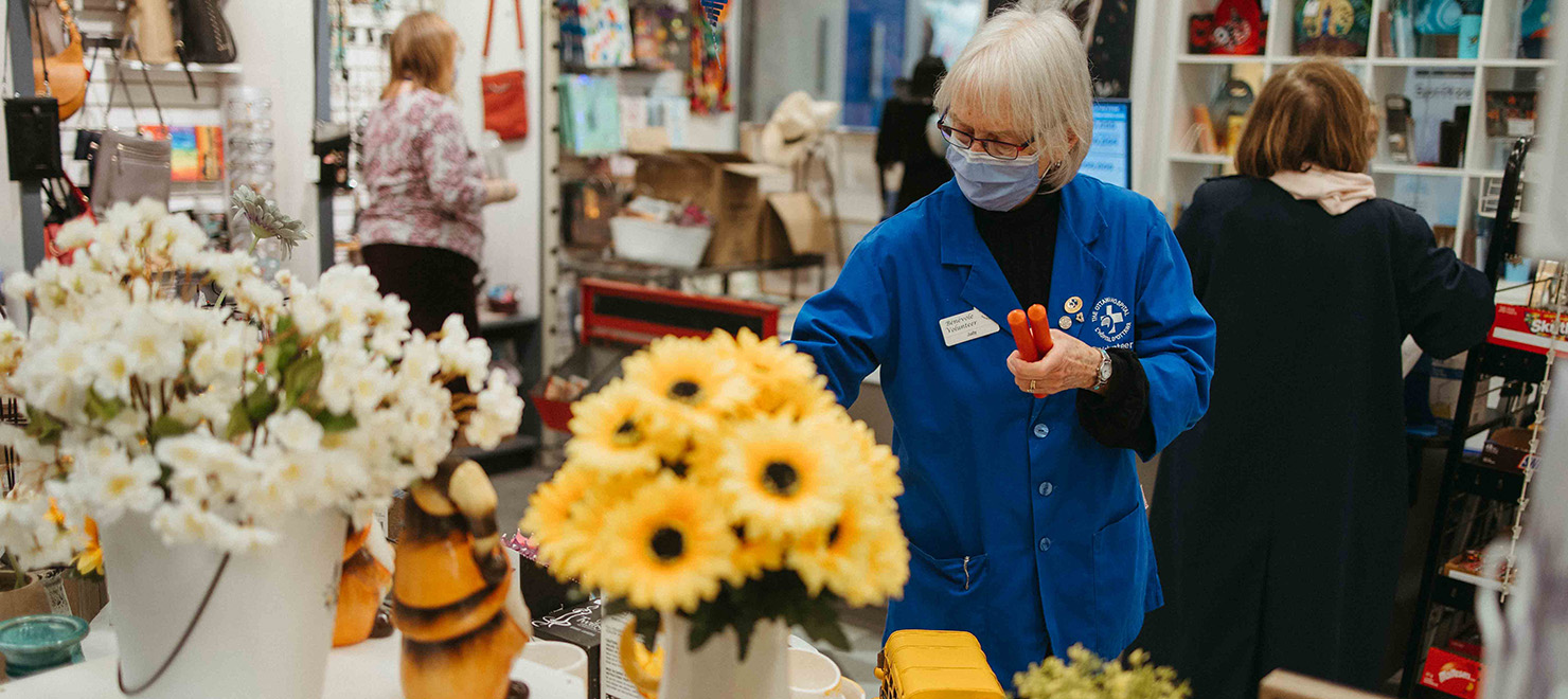 Volunteers help customers in the gift shop, La Boutique, at the General Campus