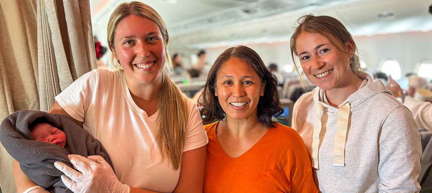 Neonatal intensive care nurses Lindsey Kilgore and Eunice Publow pose with Austrian medical resident Lena and the newborn baby girl onboard the plane.