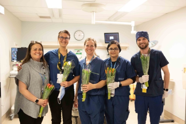 Staff members receive the bouquets.