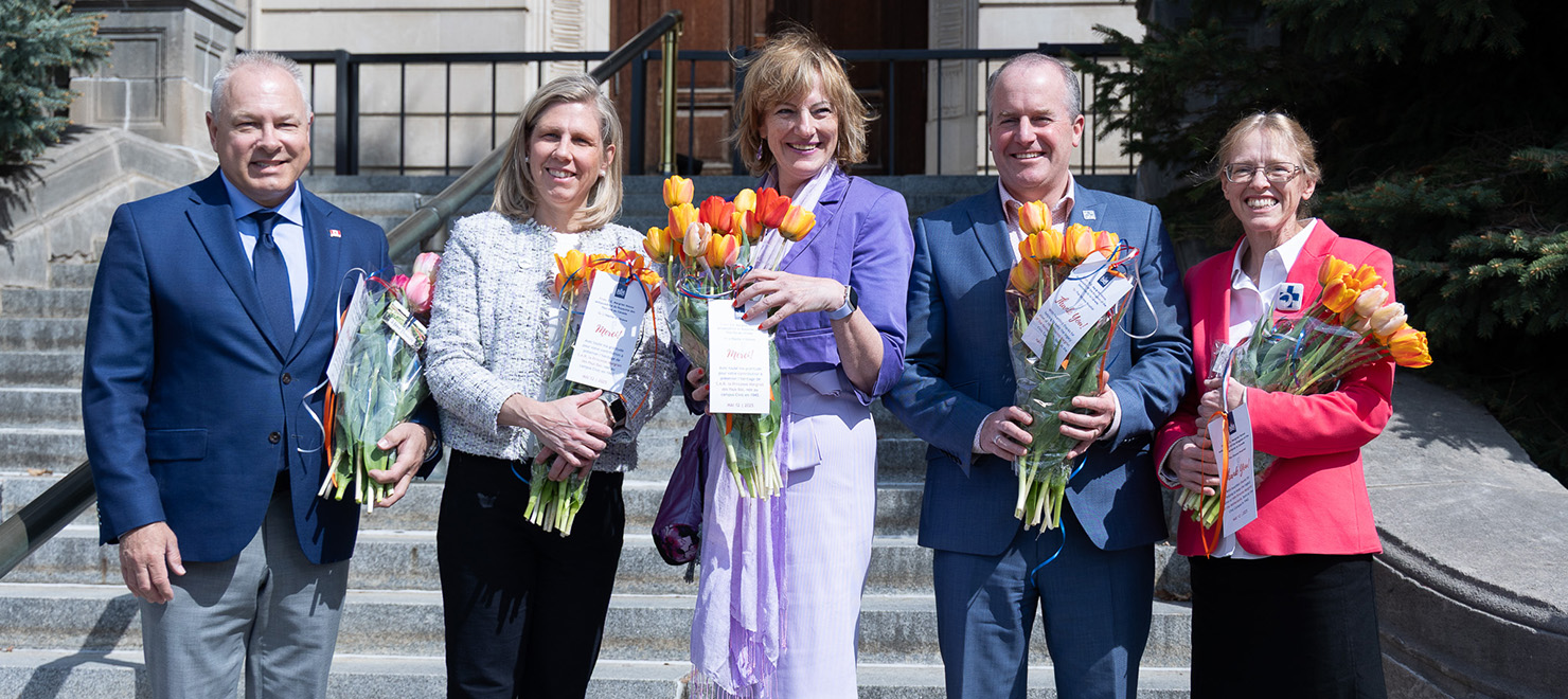 Dutch Ambassador Margriet Vonno (middle) honours our staff with a gift of tulips.