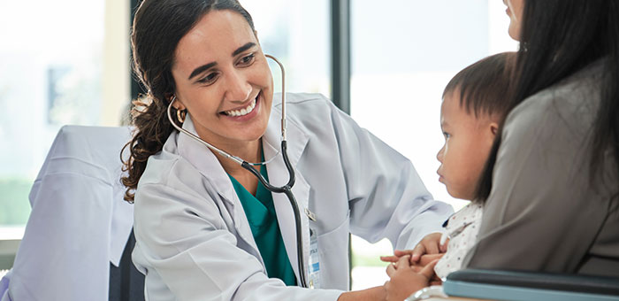 A female doctor checking a child