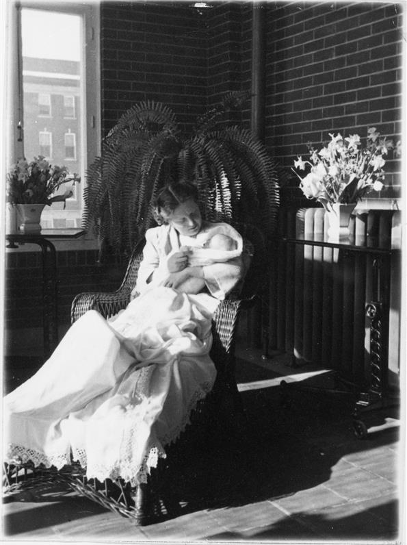 Princess Juliana of the Netherlands holds infant Princess Margriet while sitting in a wicker lounge chair at the Ottawa Civic Hospital.