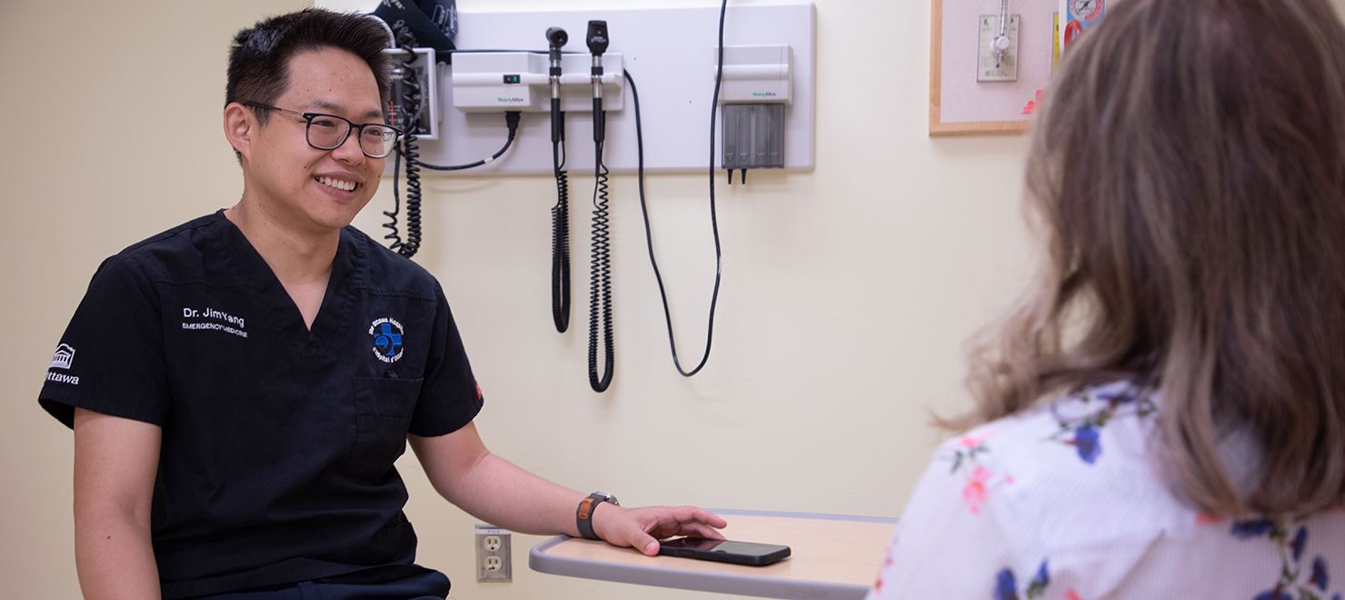 Emergency Department physician Dr. Jim Yang speaks with a patient.